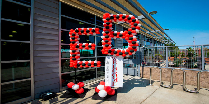 Balloons in the shape of an E & B infront of a welcome sign