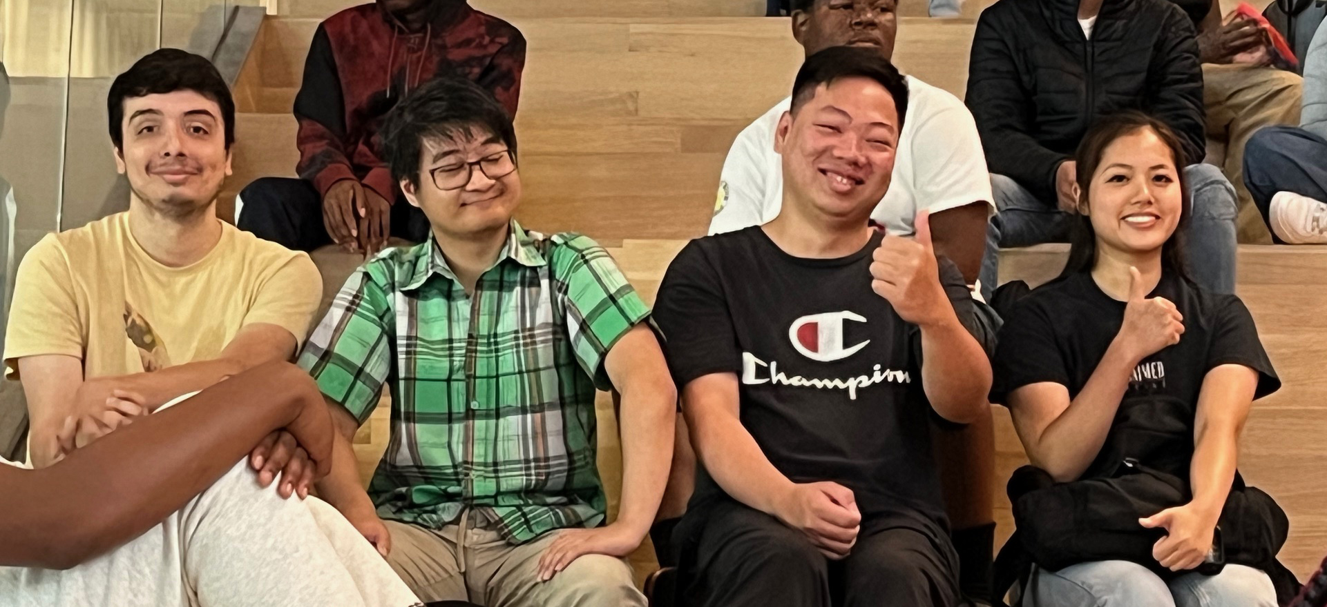 Summer Bridge students sitting on bleachers smiling.