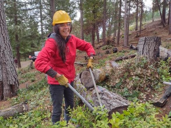 Nidhi Khosla, Associate Professor, Public Health cutting brush in the forest.