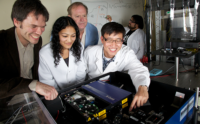 Science students working on project with professor