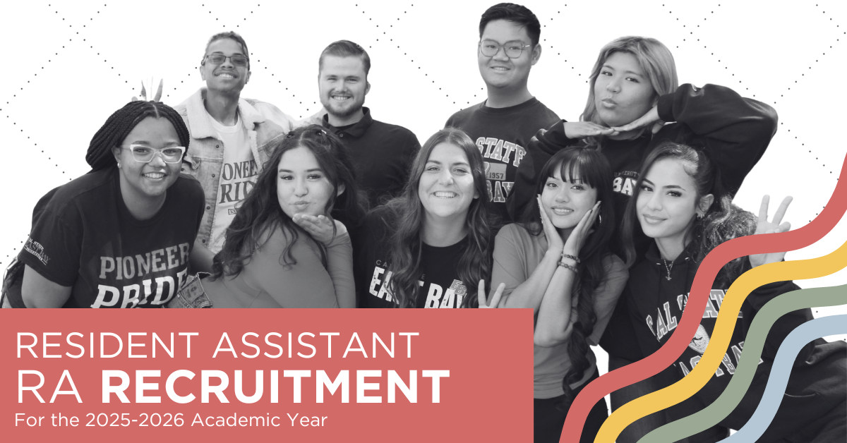 Picture of 4 student leaders wearing Cal State East Bay apparel standing in front of a residence hall with their arms around each other and laughing. 