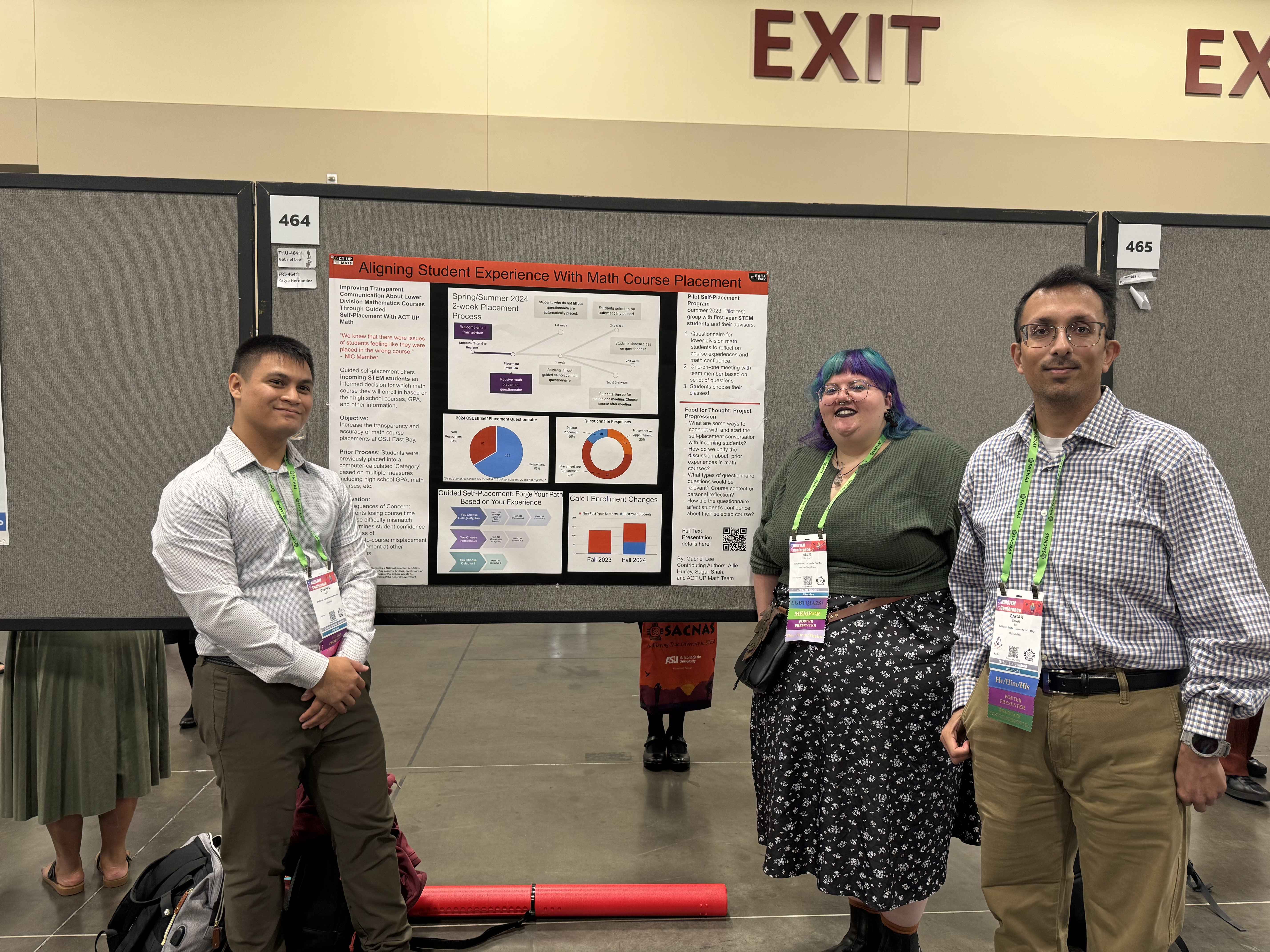 Three students gather in front of research poster