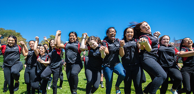 CSUEB orientation leaders jumping in a group